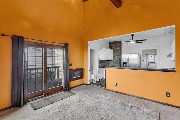 a backyard of a house with stainless steel appliances wooden floor and fence