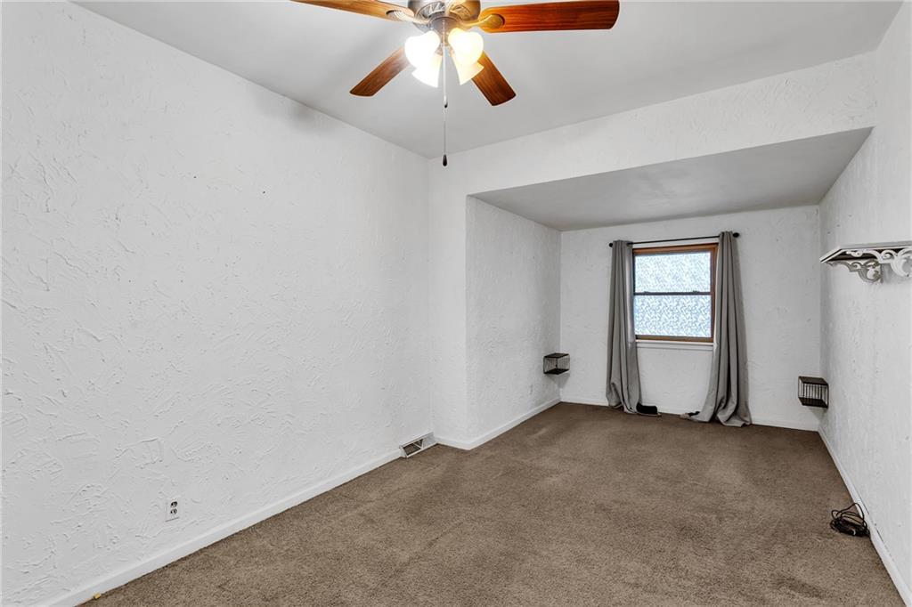 1909 Freeport Road New Kensington, PA 15068 - Photo 13 of 25 an empty room with chandelier fan and windows