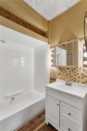 a bathroom with a bathtub and a sink