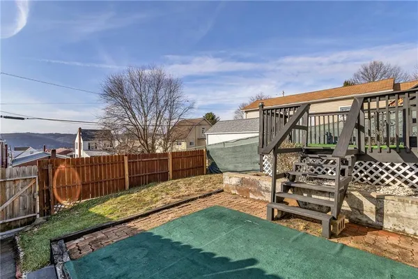 a view of a chair and table in the backyard