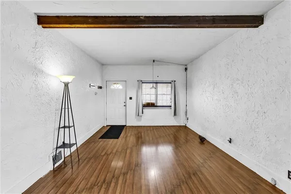 a view of a room with wooden floor and staircase