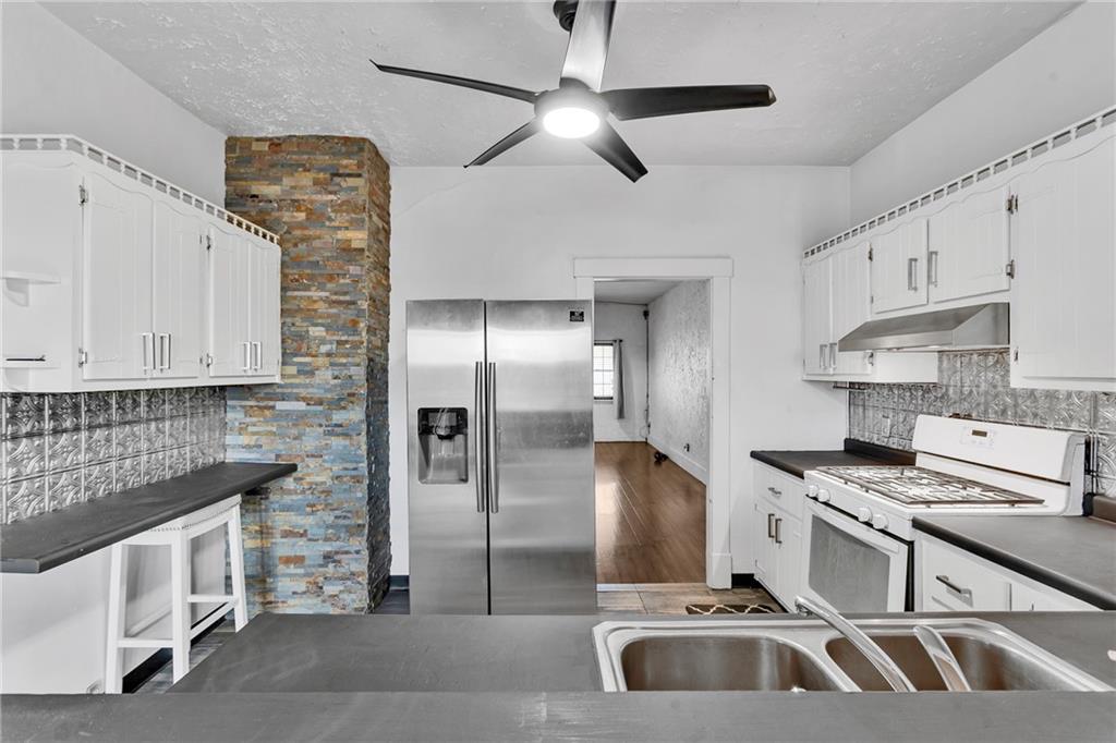 1909 Freeport Road New Kensington, PA 15068 - Photo 8 of 25 a kitchen with stainless steel appliances kitchen island granite countertop a sink and a refrigerator