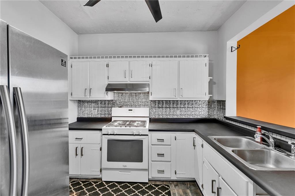 1909 Freeport Road New Kensington, PA 15068 - Photo 9 of 25 a kitchen with stainless steel appliances a sink stove and refrigerator