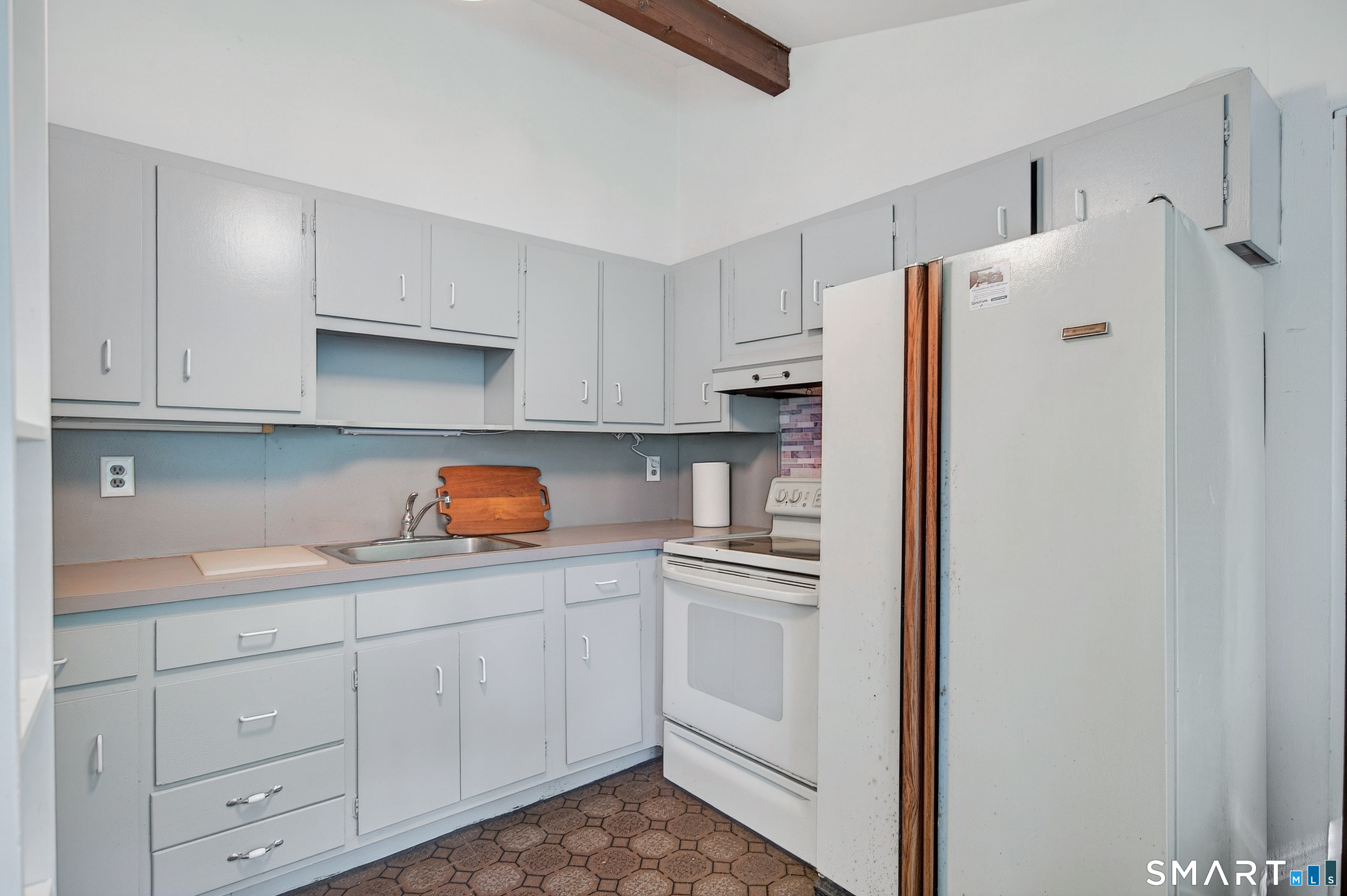 4 Pepper Pond Road Sherman, CT 06784 - Photo 11 of 33 a kitchen with white cabinets and white appliances