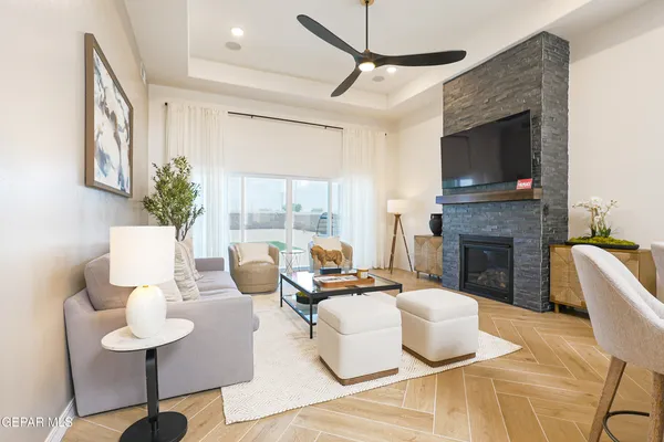 a living room with furniture fireplace and a flat screen tv