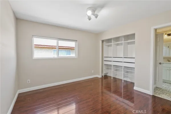 a view of wooden floor and windows in a room