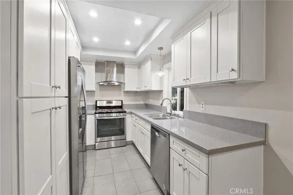 a kitchen with cabinets and stainless steel appliances