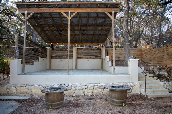 a view of a house with a small yard and wooden floor and fence