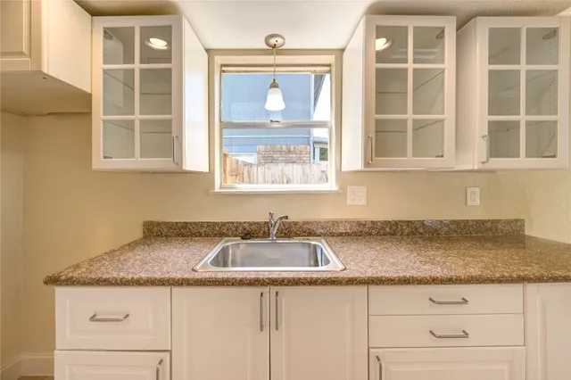 a kitchen with granite countertop window and sink