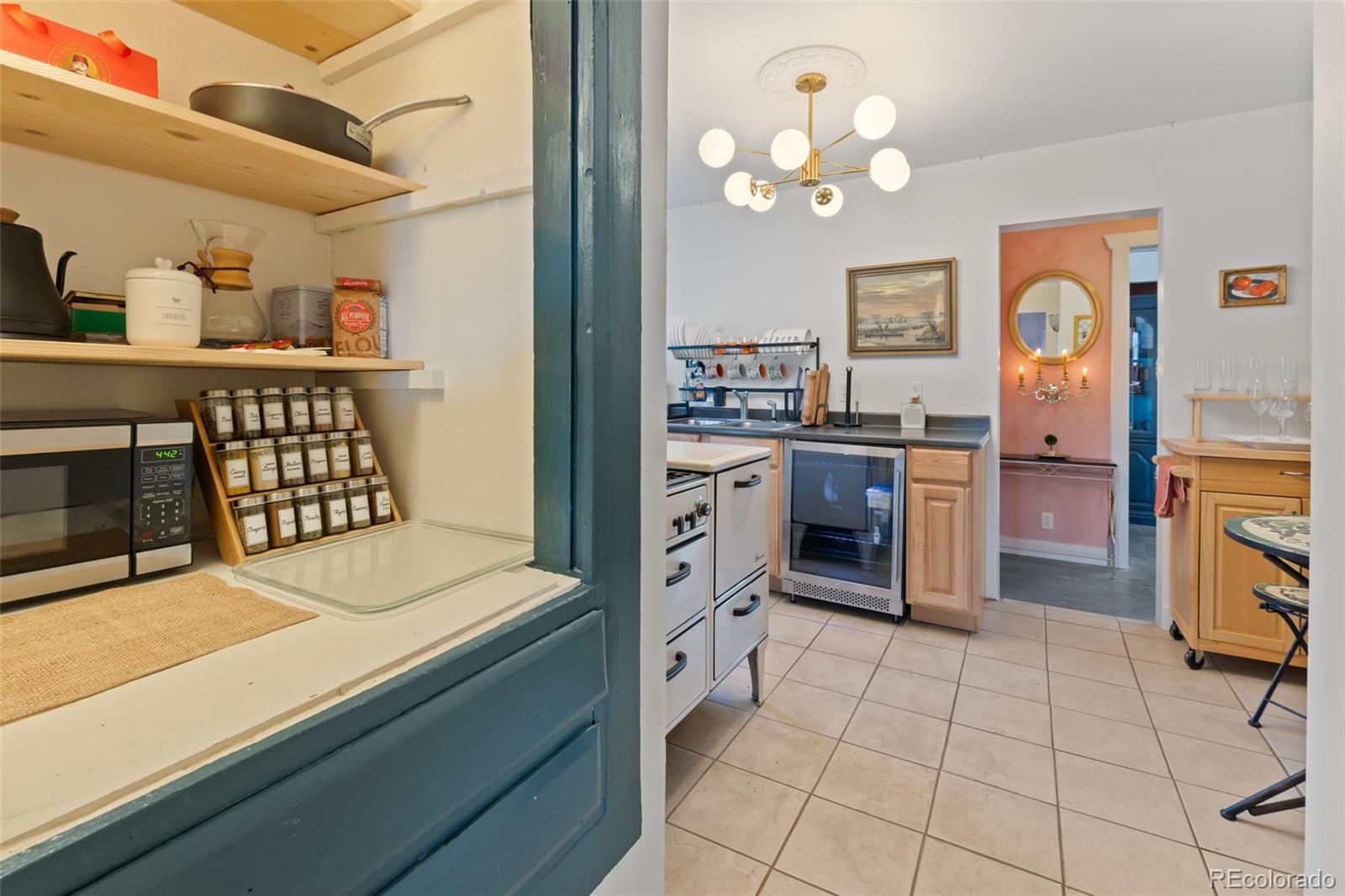 1047 Meade Street Denver, CO 80204 - Photo 12 of 38 a kitchen with stainless steel appliances granite countertop a stove top oven a sink a counter space and cabinets