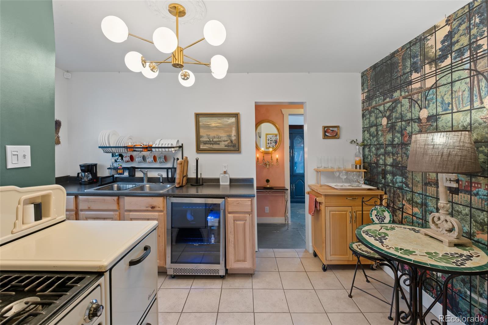 1047 Meade Street Denver, CO 80204 - Photo 13 of 38 a kitchen with a sink and cabinets