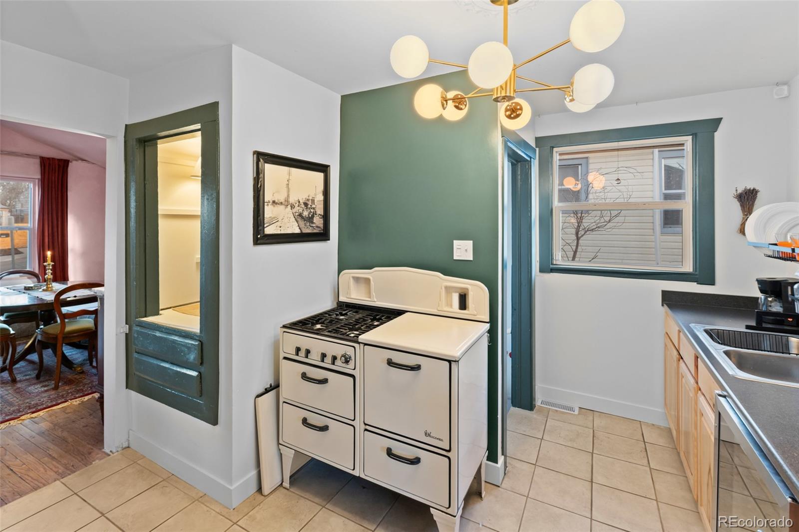 1047 Meade Street Denver, CO 80204 - Photo 15 of 38 a kitchen with a stove and a cabinet
