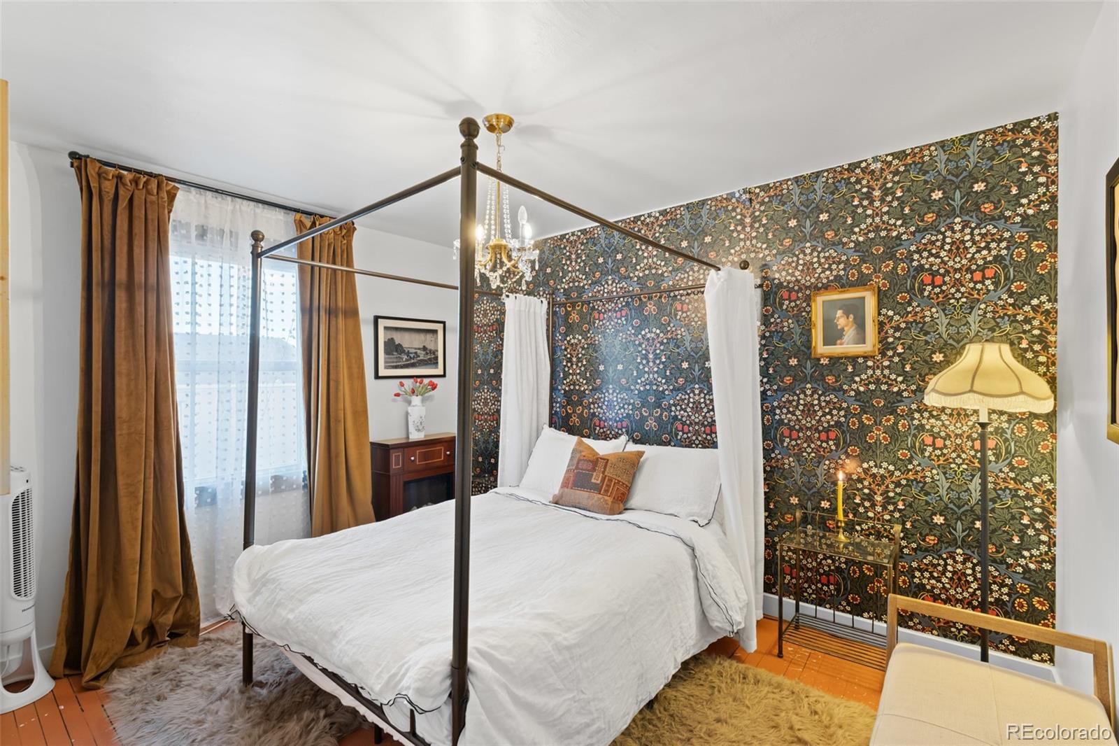 1047 Meade Street Denver, CO 80204 - Photo 20 of 38 a bedroom with a bed and wooden floor