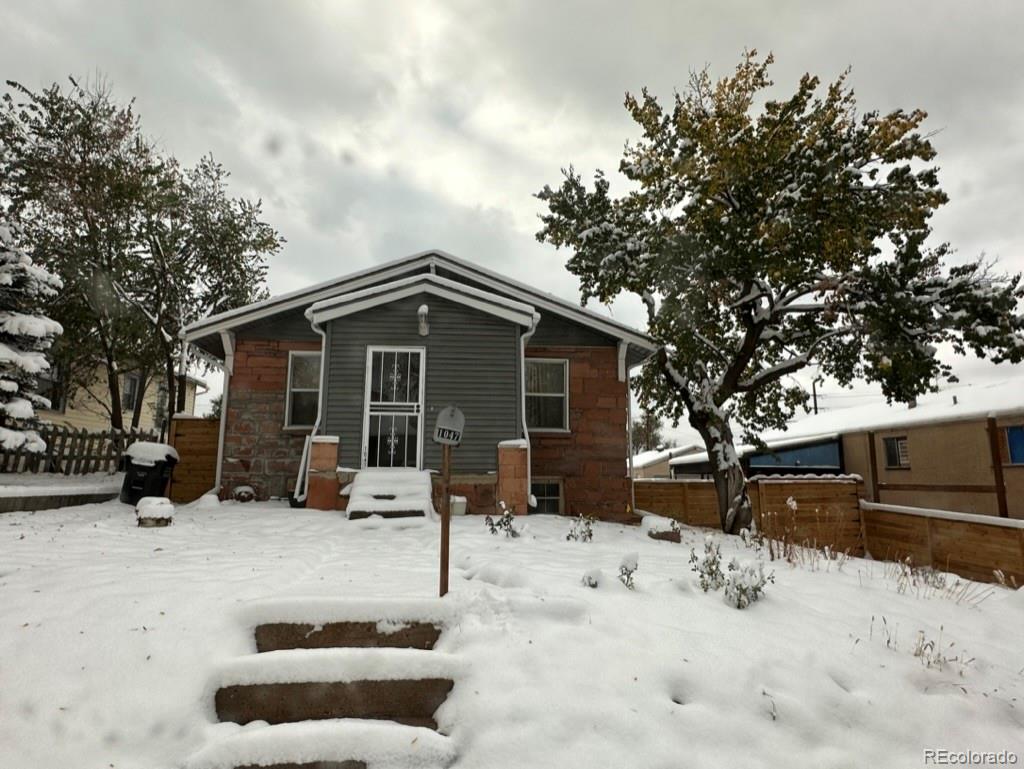 1047 Meade Street Denver, CO 80204 - Photo 2 of 38 a view of house with a yard covered in snow