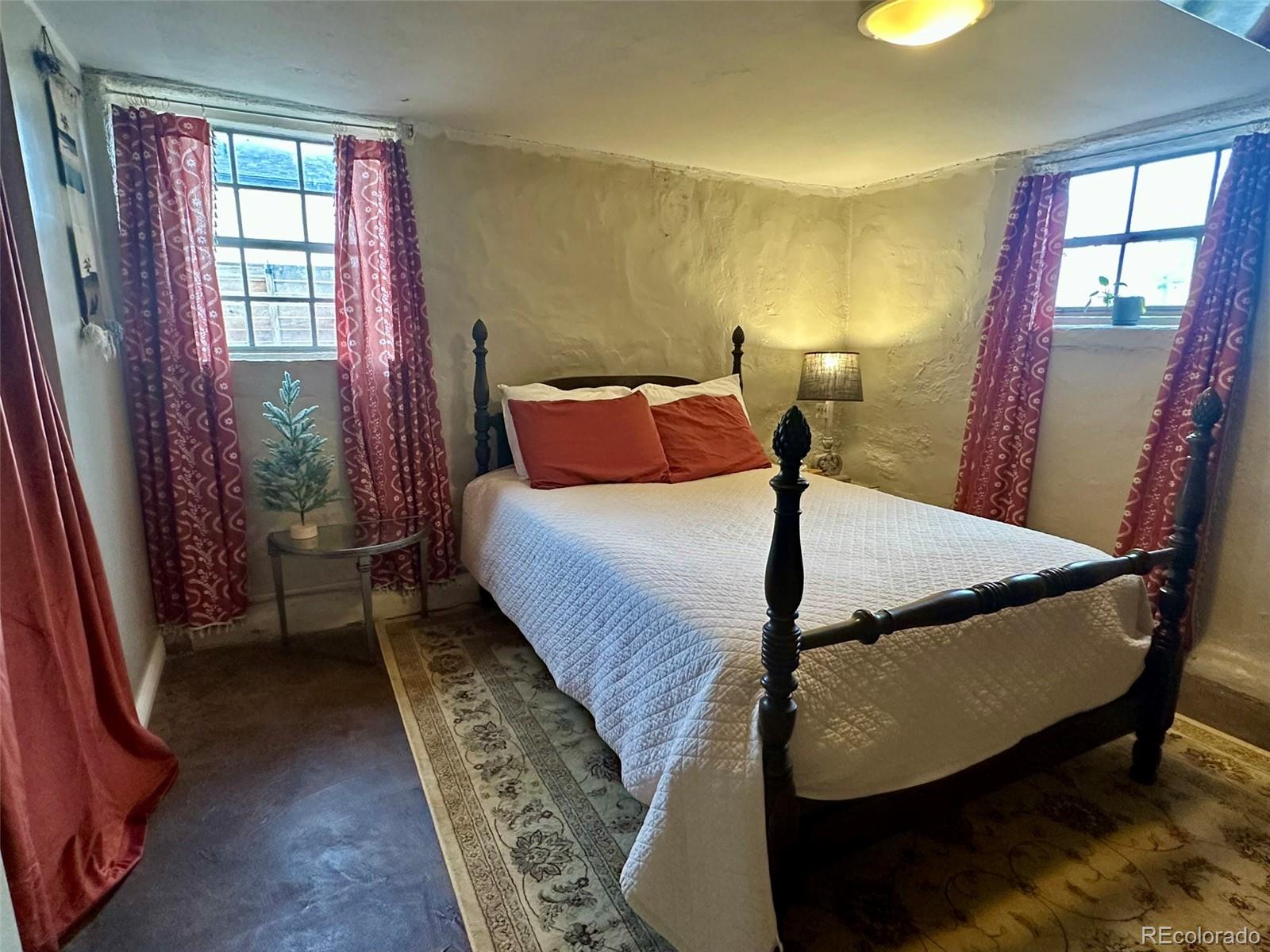 1047 Meade Street Denver, CO 80204 - Photo 28 of 38 a bedroom with a bed and window