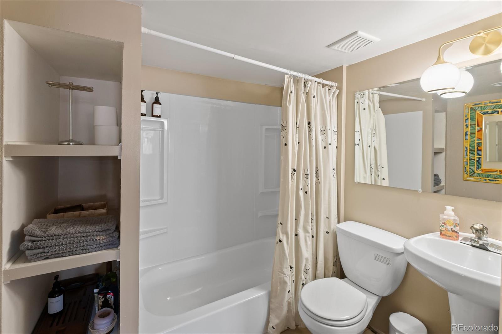 1047 Meade Street Denver, CO 80204 - Photo 31 of 38 a bathroom with a toilet sink and shower