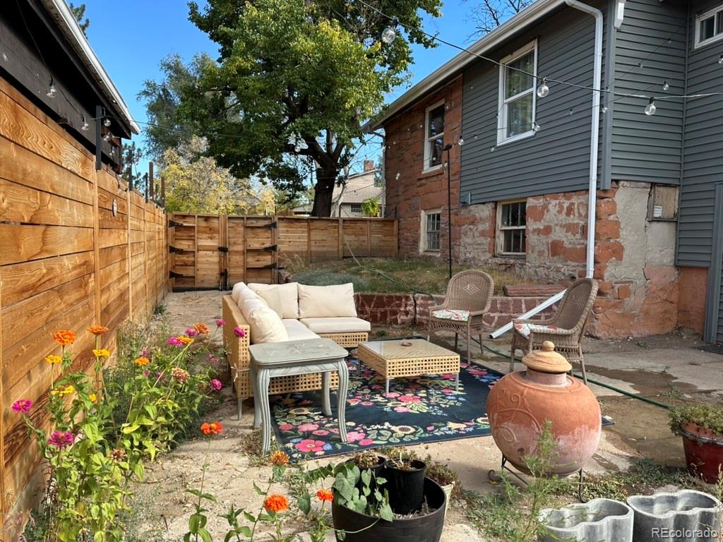 1047 Meade Street Denver, CO 80204 - Photo 35 of 38 a view of a patio with table and chairs and potted plants