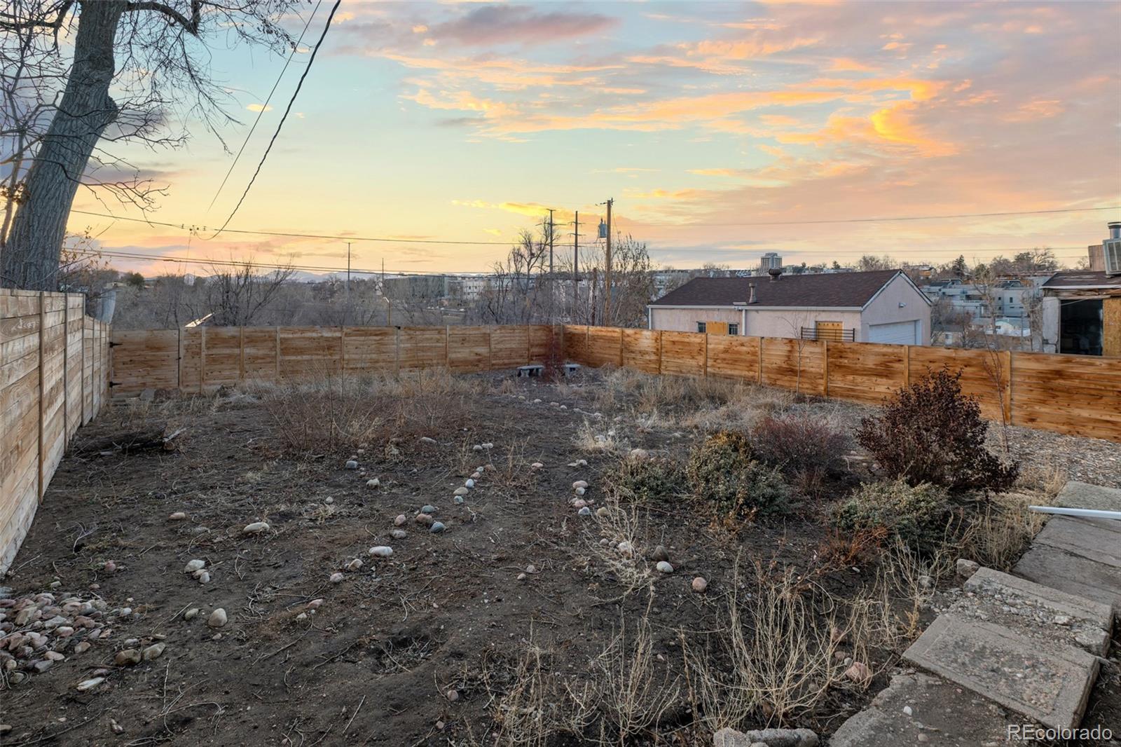 1047 Meade Street Denver, CO 80204 - Photo 37 of 38 a view of a dry yard with wooden fence