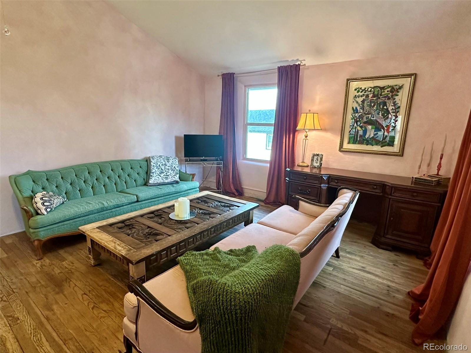 1047 Meade Street Denver, CO 80204 - Photo 8 of 38 a living room with furniture and a wooden floor