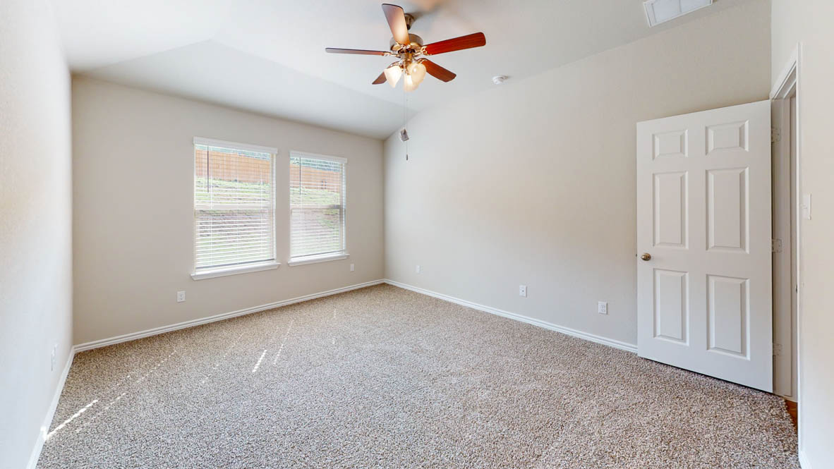 429 Creekfall Road Burnet, TX 78611 - Photo 22 of 28 A spacious chamber awaits, offering vaulted ceilings and natural light.