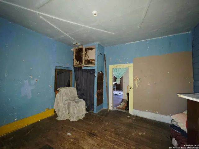 a view of an empty room and wooden floor