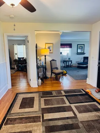 a gym area with lots of furniture and view of living room