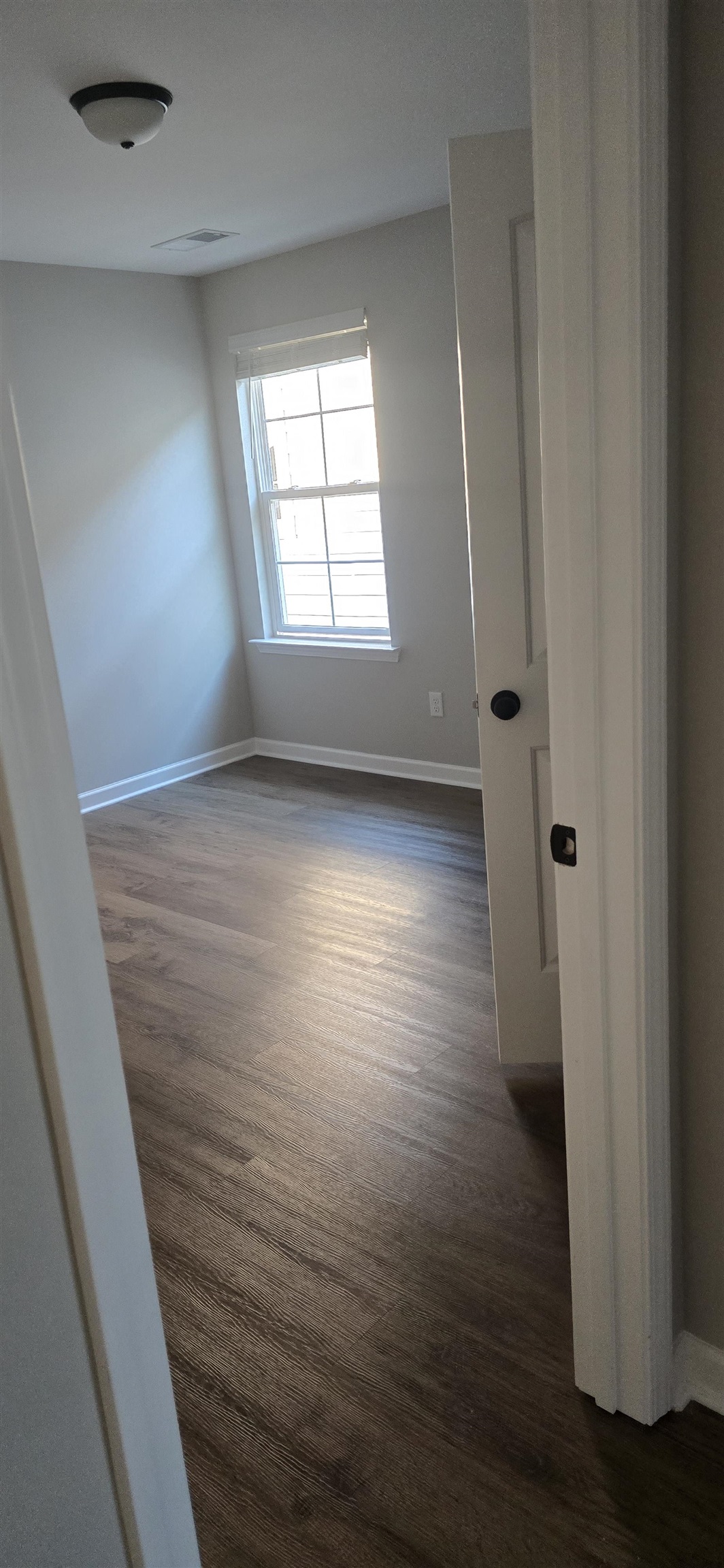 10148 Sterling Ridge Drive Cordova, TN 38018 - Photo 14 of 39 an empty room with wooden floor and windows