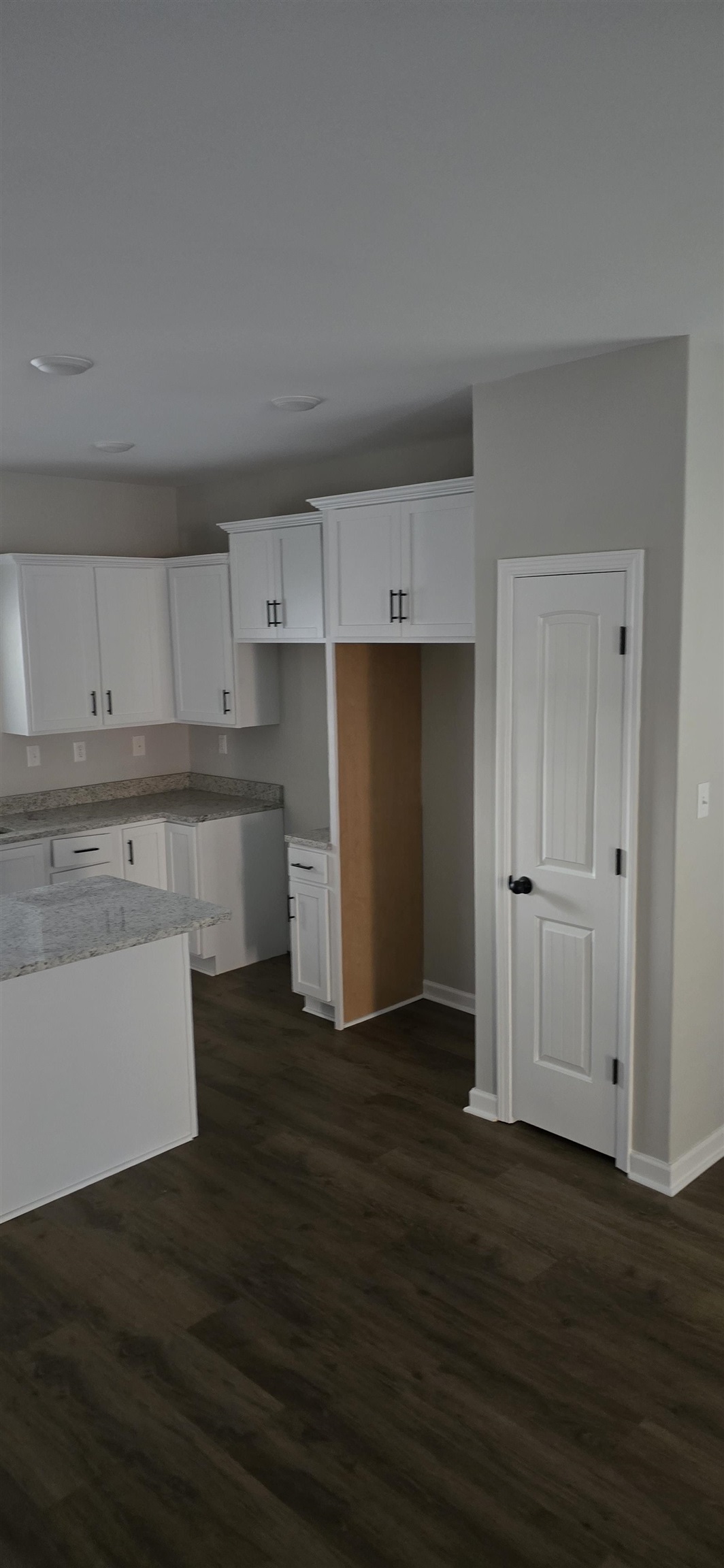 10148 Sterling Ridge Drive Cordova, TN 38018 - Photo 23 of 39 a kitchen with wooden floors and white cabinets