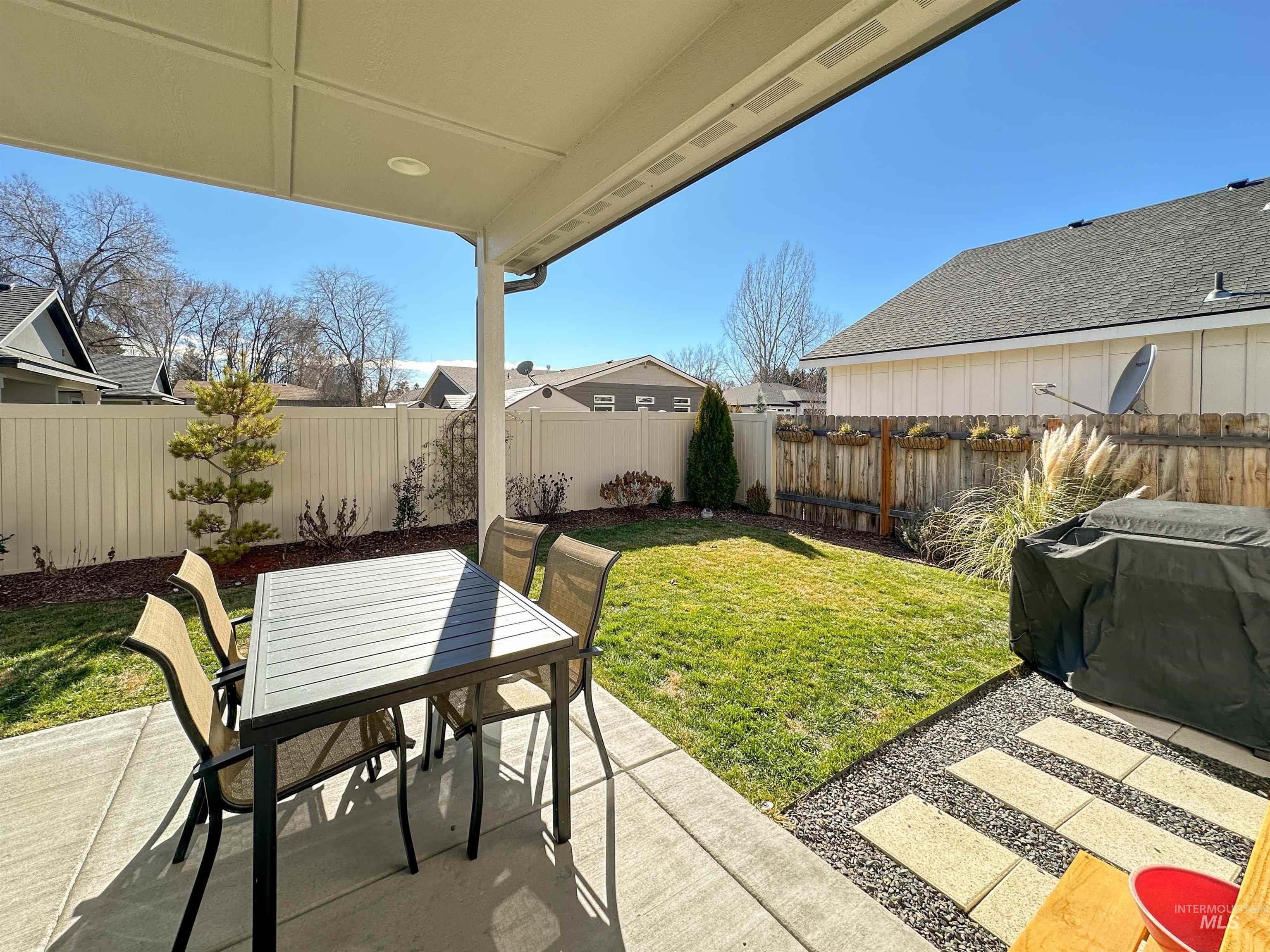 9687 West Arnold Road Boise, ID 83714 - Photo 32 of 37 Covered patio with recessed lighting, concrete patio surface, gravel and paver stepping stones, and a manicured lawn