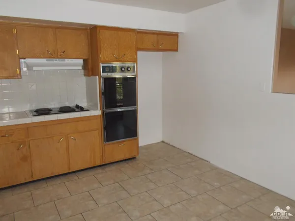 a kitchen with cabinets and stainless steel appliances