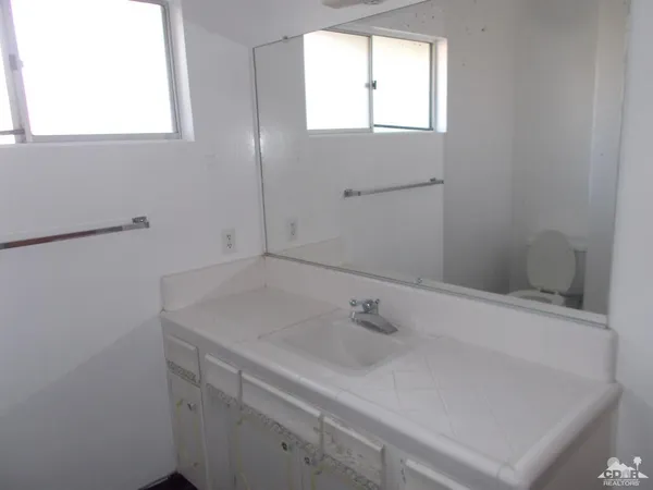 a bathroom with a sink and a window