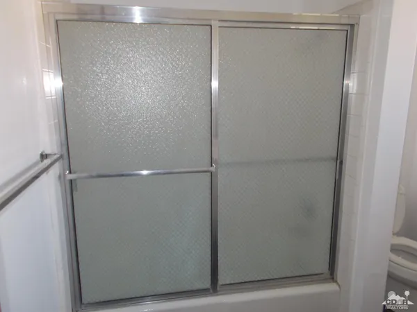 a bathroom with a glass shower door