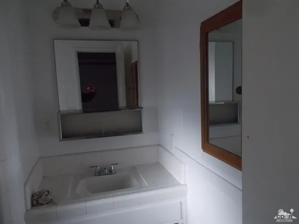 a bathroom with a sink and mirror