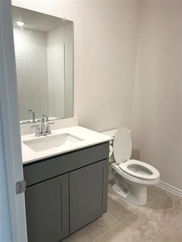 a bathroom with a sink toilet and mirror