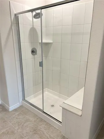 a bathroom with a glass shower door