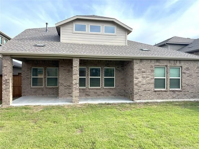 a front view of a house with a garden and yard