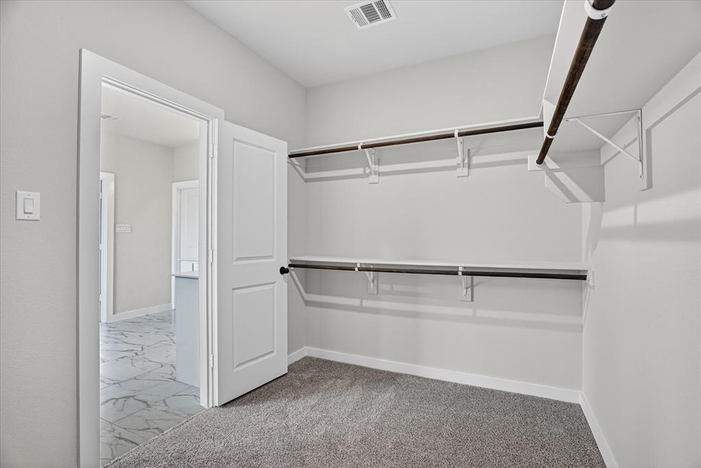 317 Skeen Peak Springtown, TX 76082 - Photo 26 of 31 Spacious closet with built-in shelving and hanging rods