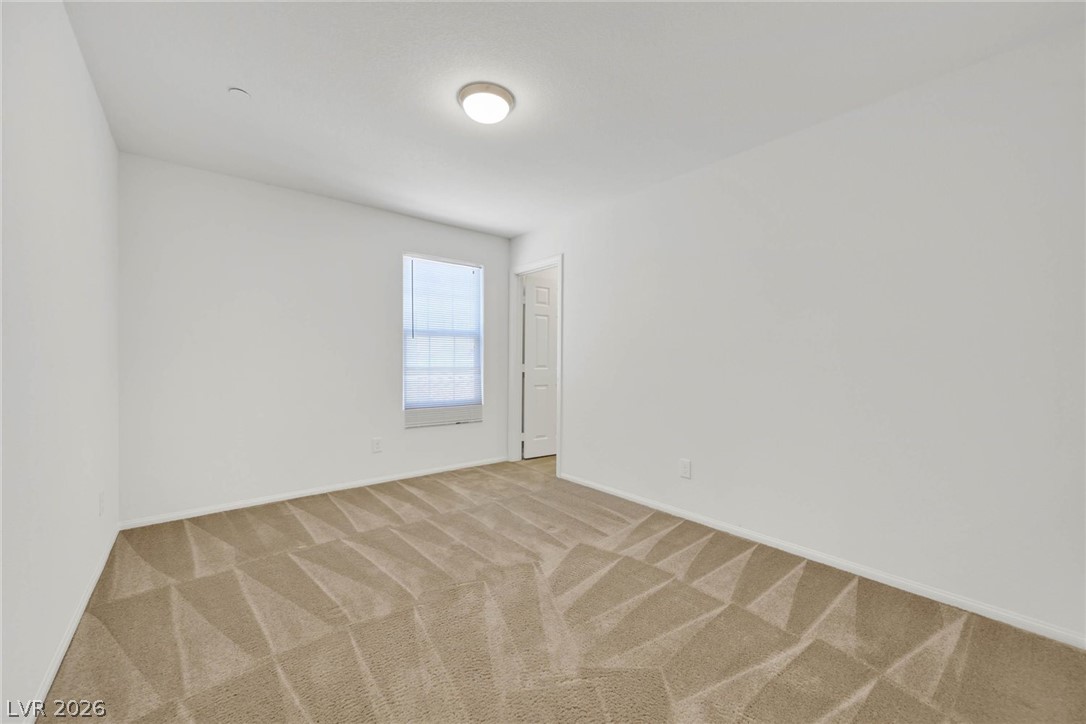 155 Fulgora Street Henderson, NV 89074 - Photo 15 of 30 A spacious, neutral room offers a clean canvas for your personal style, complete with a window for natural illumination.