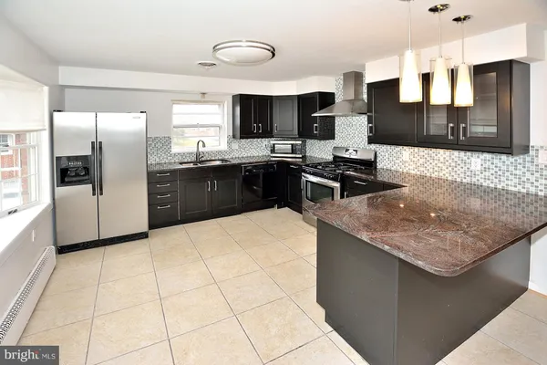 a large kitchen with stainless steel appliances kitchen island granite countertop a large counter top stainless steel appliances and cabinets