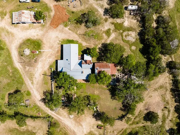 an aerial view of a house with a yard basket ball court