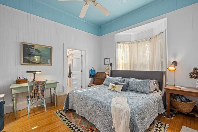 a bedroom with a bed and a table in it