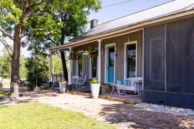 a view of a house with backyard and sitting area