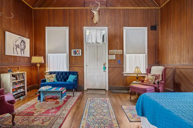 a bedroom with furniture and a rug