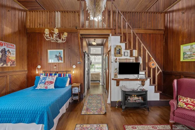 a bedroom with furniture and a fireplace