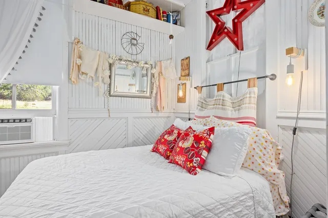 a bedroom with a bed and a window