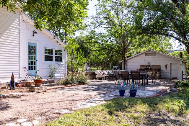 a backyard of a house with yard and outdoor seating