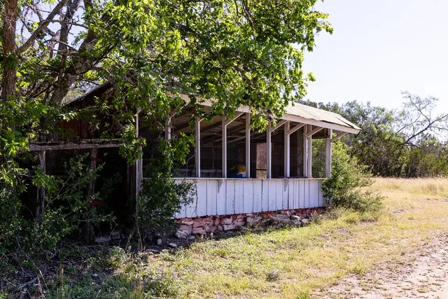 a view of a house with wooden fence and garden