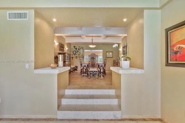 a view of a dining room with furniture and chandelier