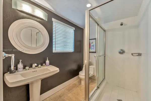 a view of a dining room with furniture and a chandelier fan