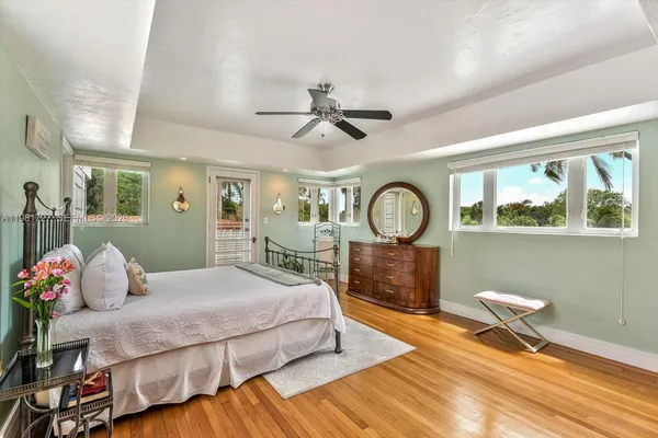 a living room with furniture and a baby crib